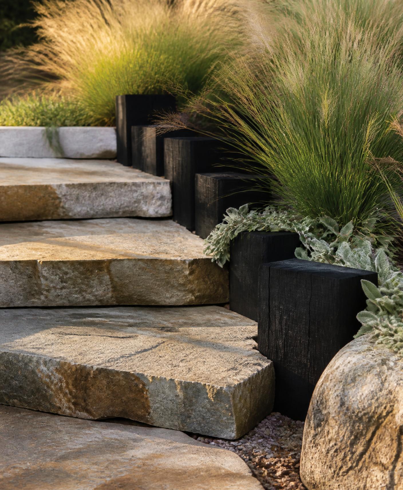 Natural stone steps, charred timber edging and native grasses